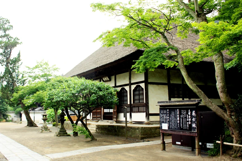 there is a large brown house with a thatch roof