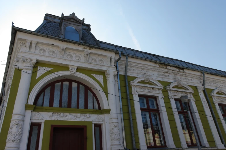 the front of a building with many windows and doors