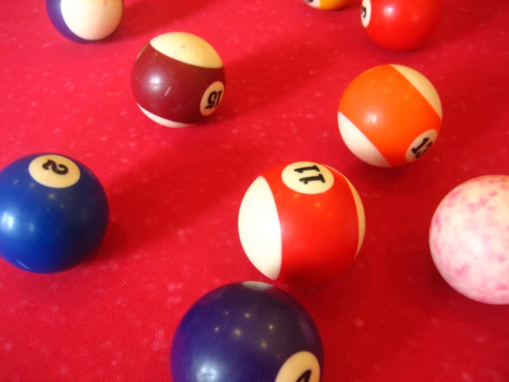 an array of billiard's balls sitting on top of red carpet