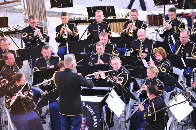 band members dressed in black and gold playing music instruments