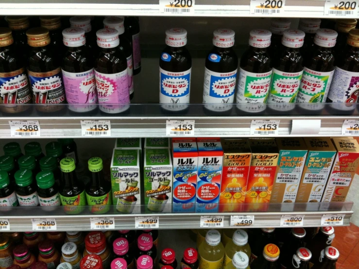 a grocery store shelf filled with juice and drinks