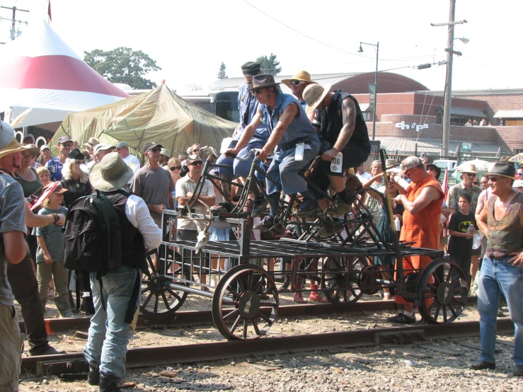 people standing around and around a wooden carriage