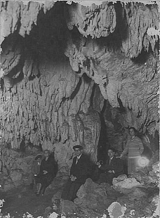 men in the cave with a woman and children