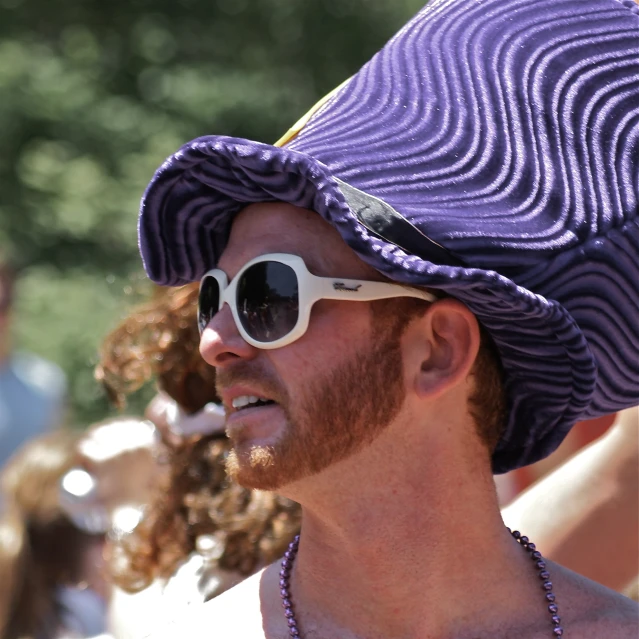 a man in a purple hat with sun glasses