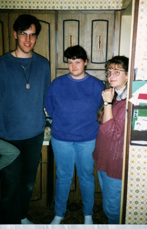 three people standing around looking at the camera