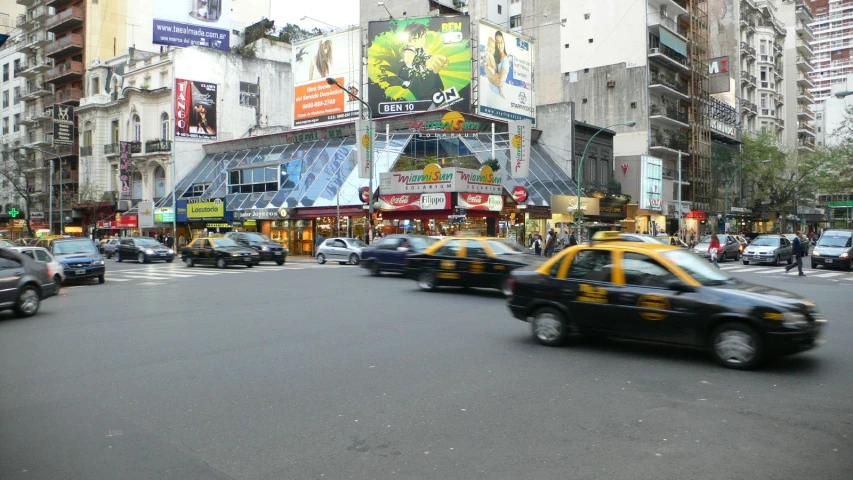 the cars are making their way through the busy city streets