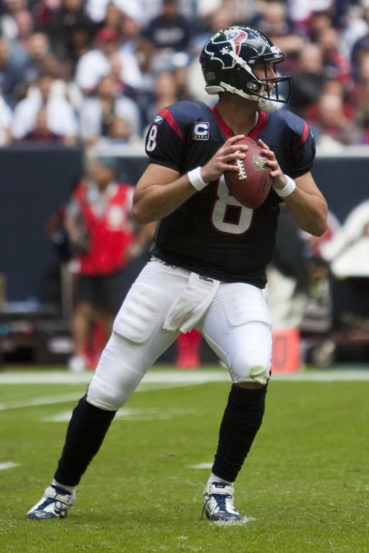 a person playing football in the grass