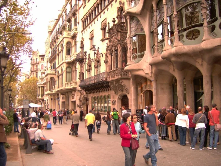 people walking on the sidewalk outside the building