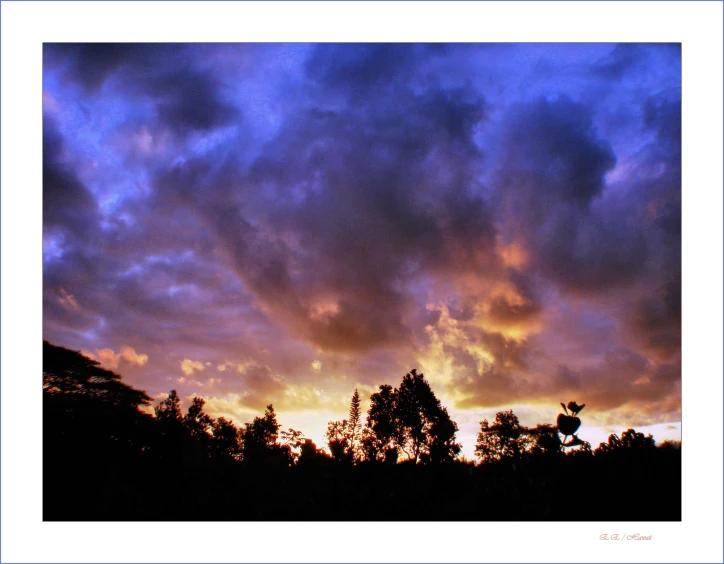 a dark blue sunset sky with white clouds