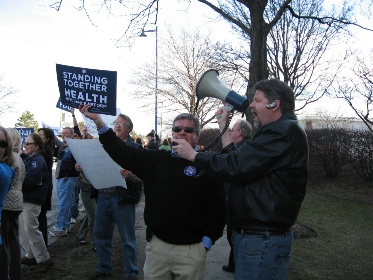 a man holding up a sign with a megaphone