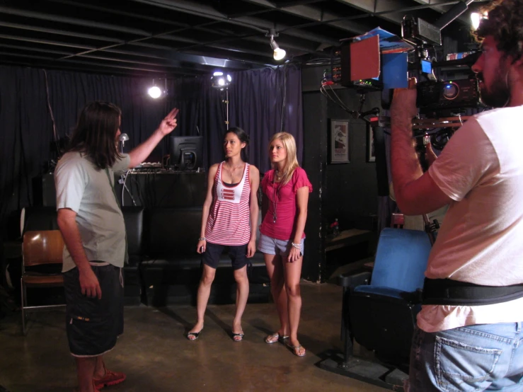 several people standing in front of a tv camera