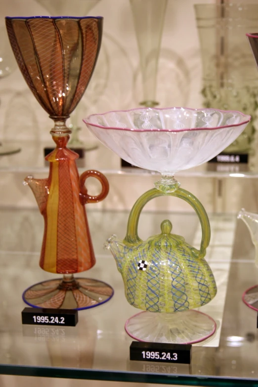 four different glass items sitting on display together