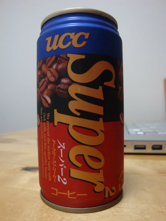 the can of coffee sits on top of a desk