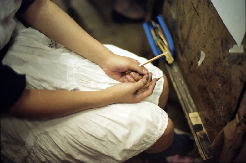 a woman looking at an object in her hands