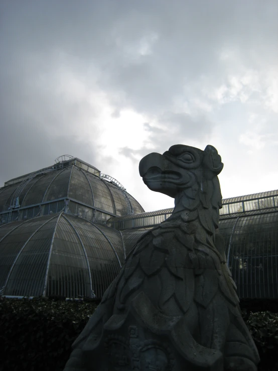 a large sculpture near some building with many windows