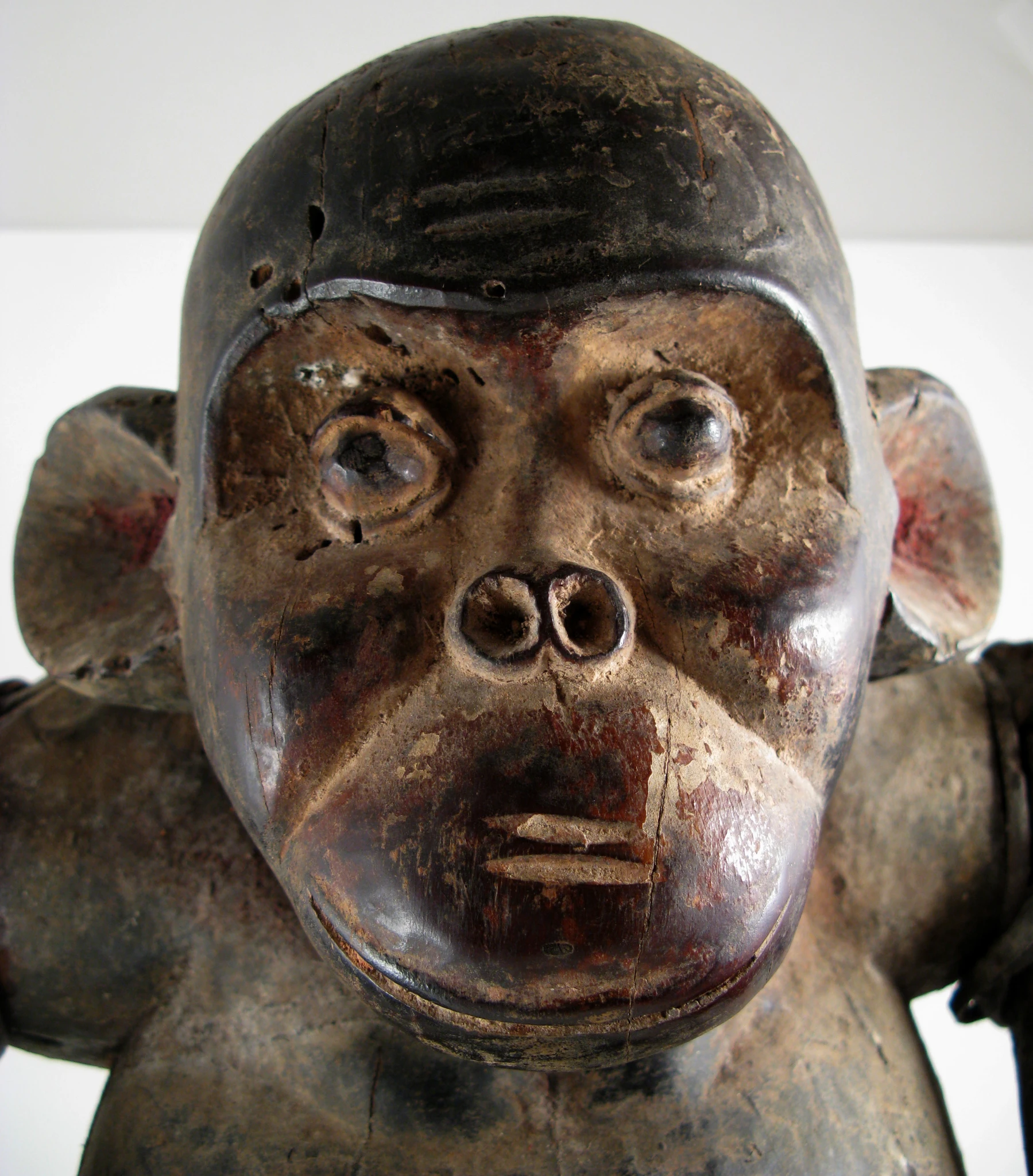 a wooden statue with some strange eyes