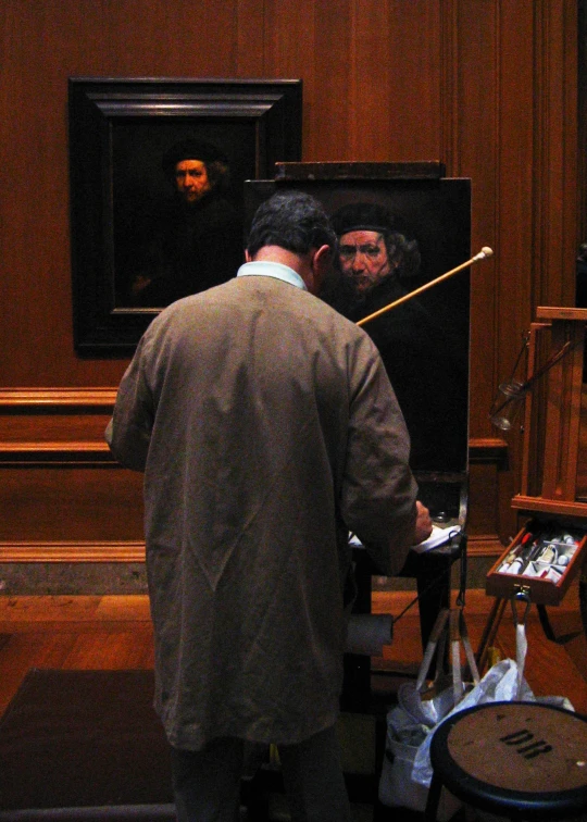 a man looks at his reflection in the mirror