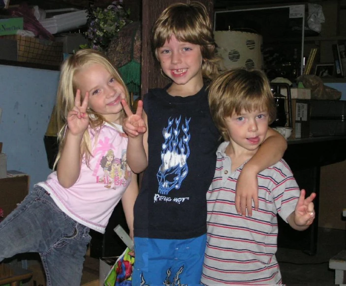 three s holding up their fingers while posing for a picture