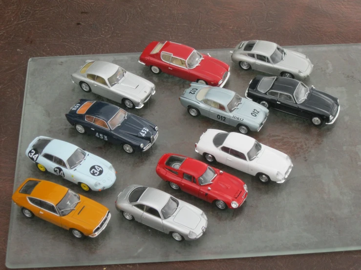 several colorful model cars sit in the middle of a display