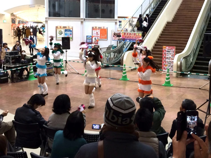 the group of girls in costume are dancing