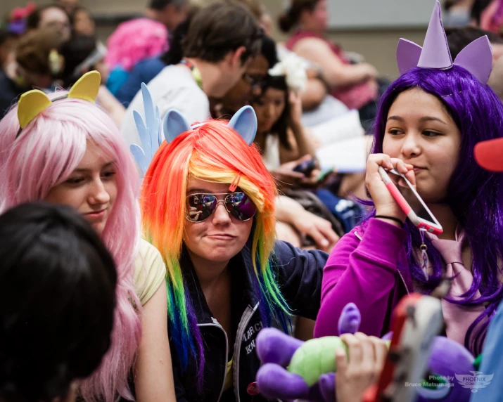 two girls in rainbow wigs and purple hair