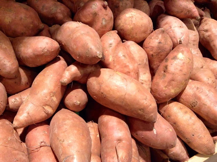 there is a pile of brown sweet potatoes