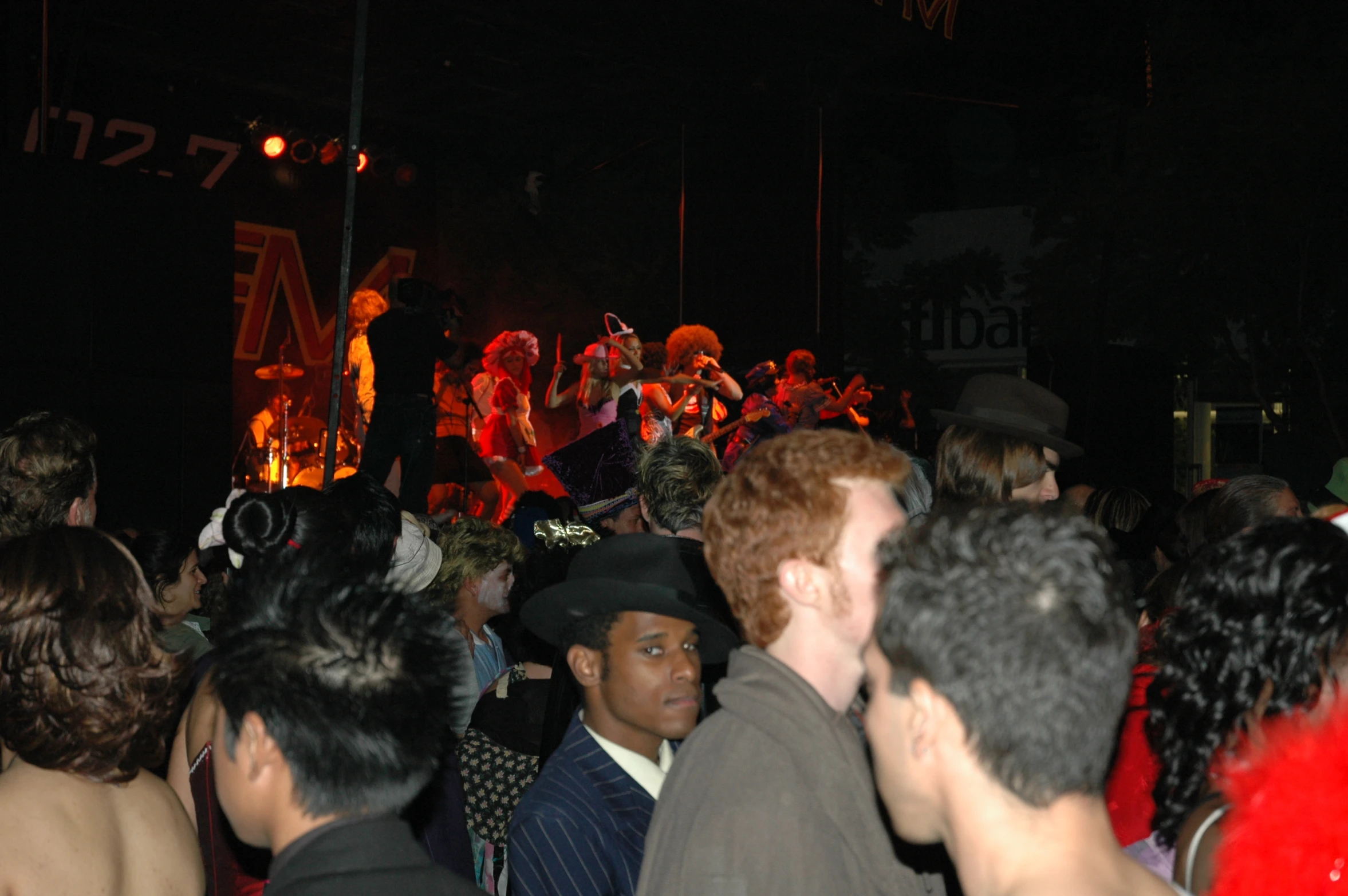 a crowd of people standing in the middle of a concert