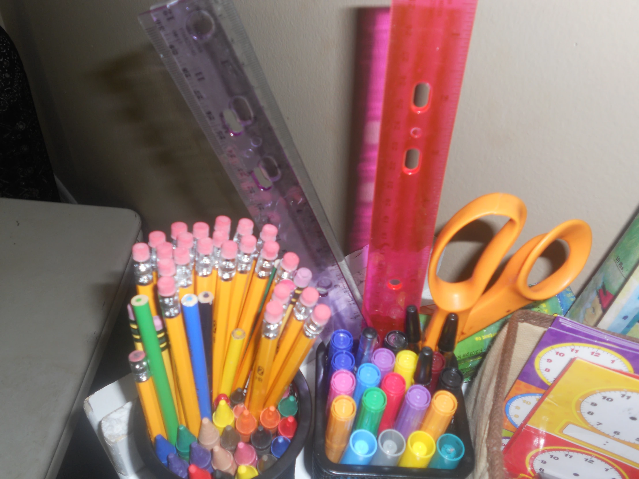 pencils, markers and other office supplies on a desk