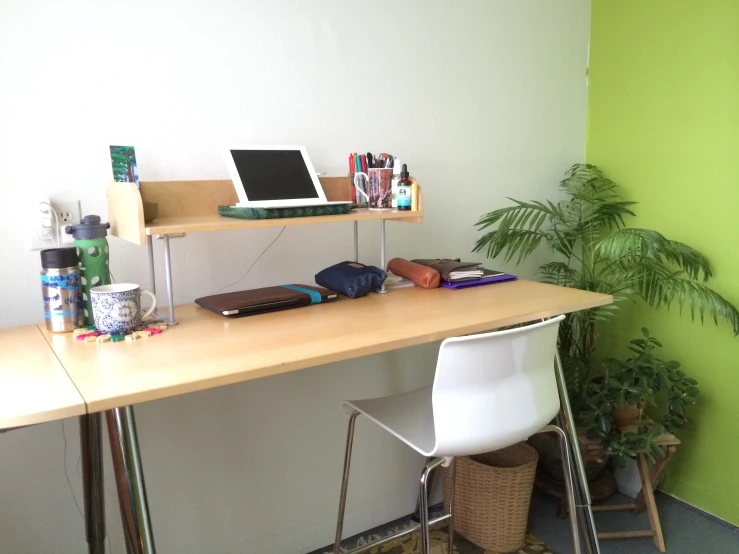 a desk in the corner with a laptop on it