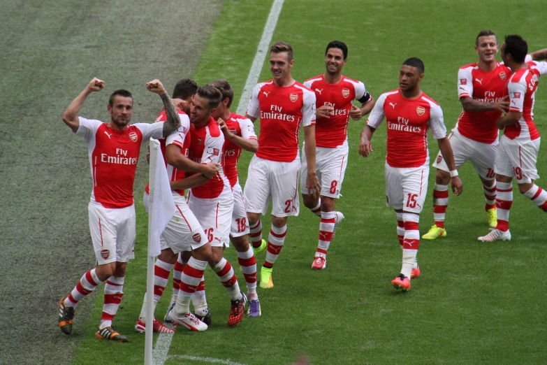 the soccer players are celeting after winning their match