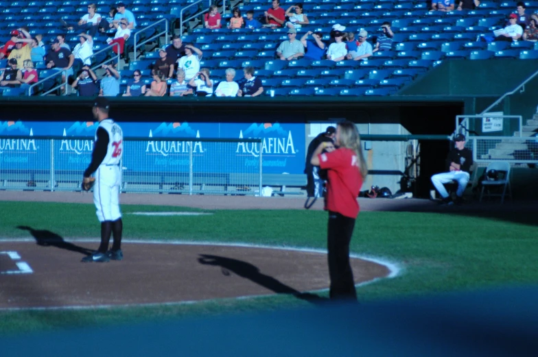 a crowd of people watching a baseball game on a field