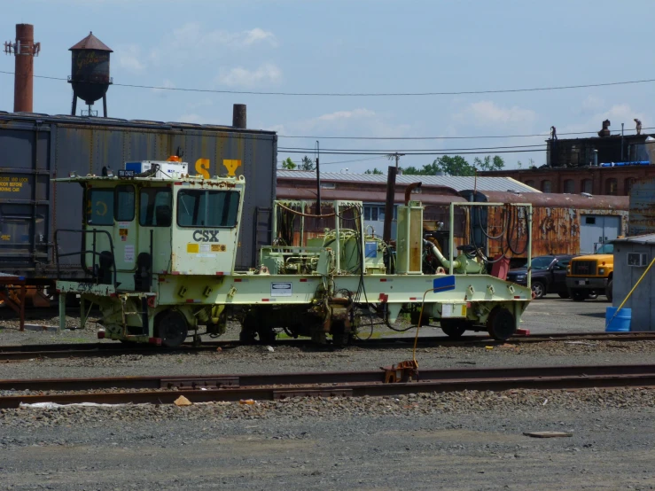 an old train sitting on the tracks in a yard