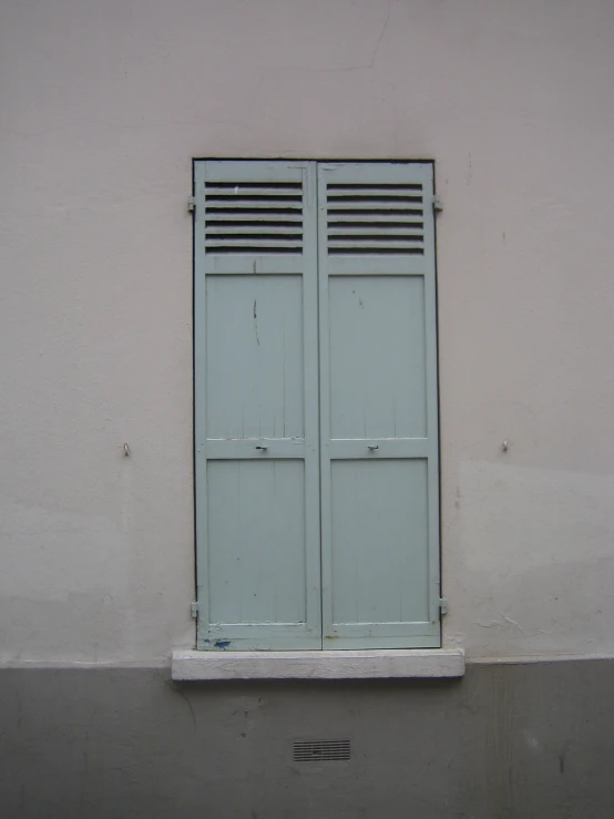 a grey and white wall with a closed door