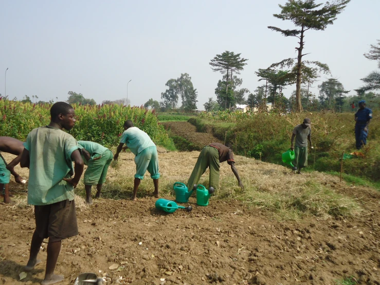 several men in the middle of a dirt field