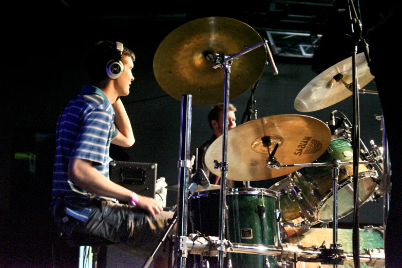 there is a young man sitting on a stage