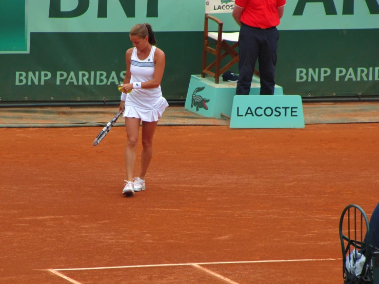 a woman standing on a tennis court holding a racquet