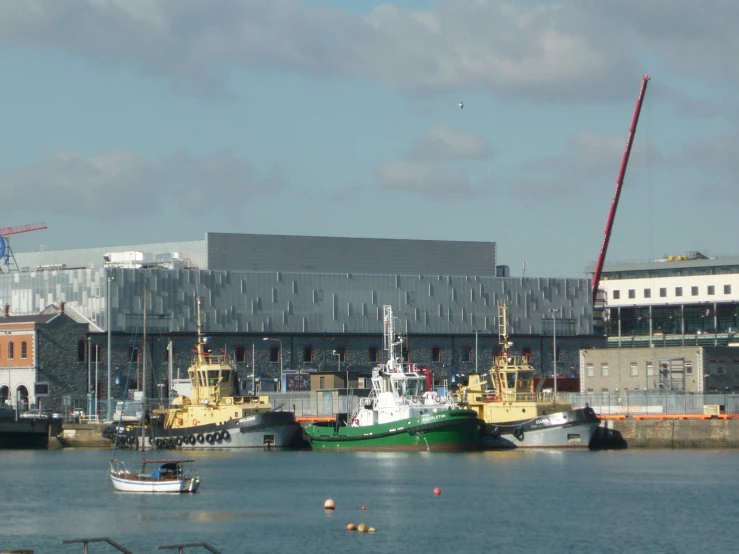 a boat is out in the harbor next to other ships