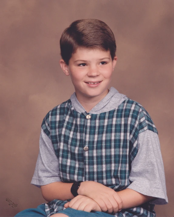 a  in a blue plaid shirt posing