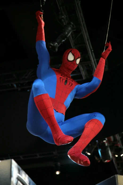 a spiderman performs a stunt on stage