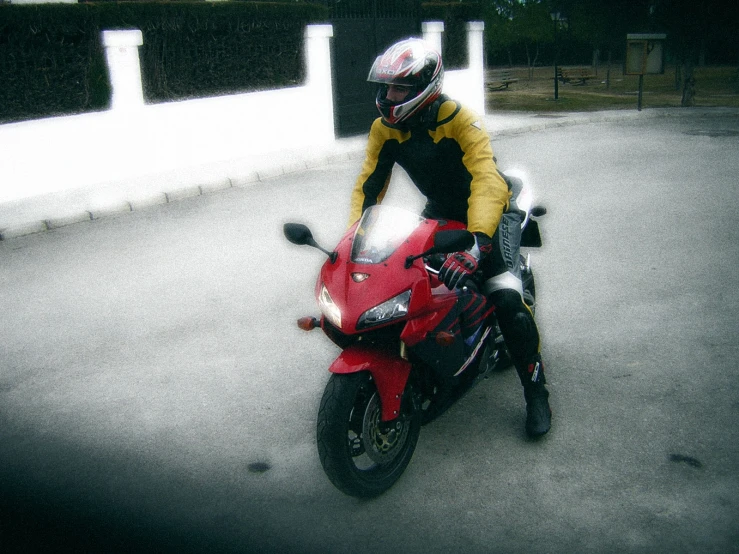 a man sits on the motorcycle while wearing a helmet