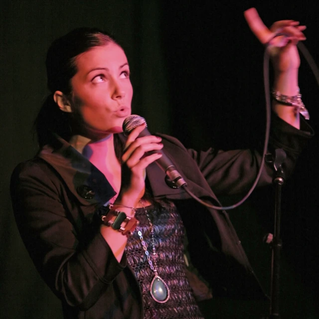 a woman standing in front of a microphone