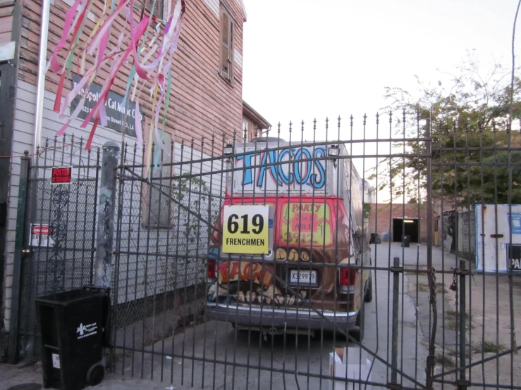 the back of a large bus parked next to a building