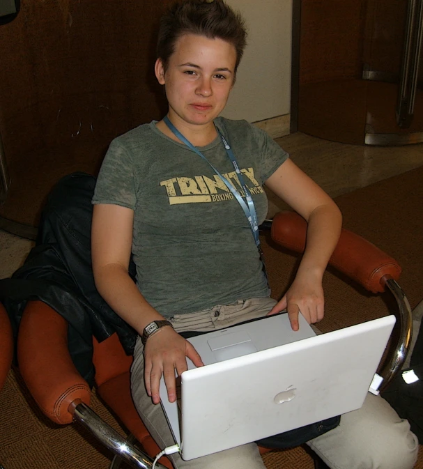 a woman sitting in a chair with her laptop