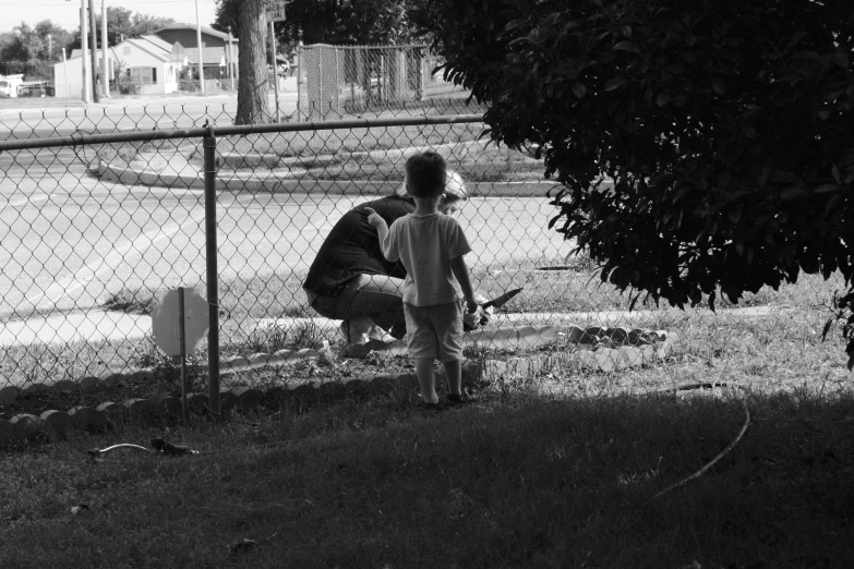 two s playing in the grass