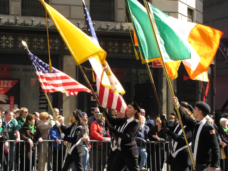 a bunch of people that are walking with flags