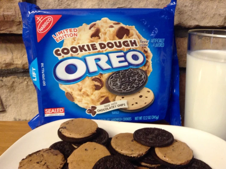 oreo cookies and milk on plate near bag of cookies