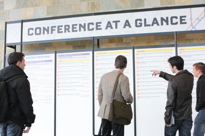 people are standing near a sign with a message on it