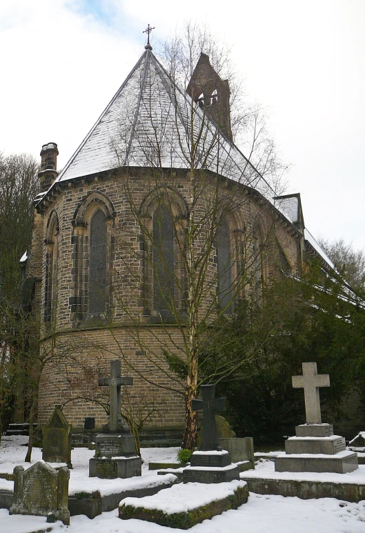 a tall brick building with a pointed roof