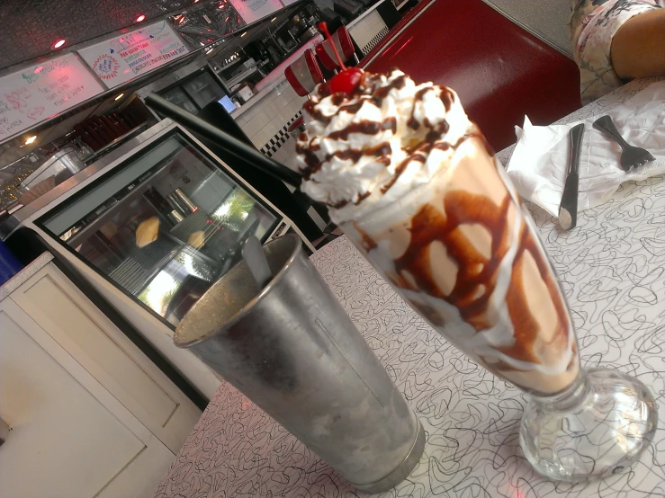 the large ice cream sundae has been decorated with chocolate, banana and cherries