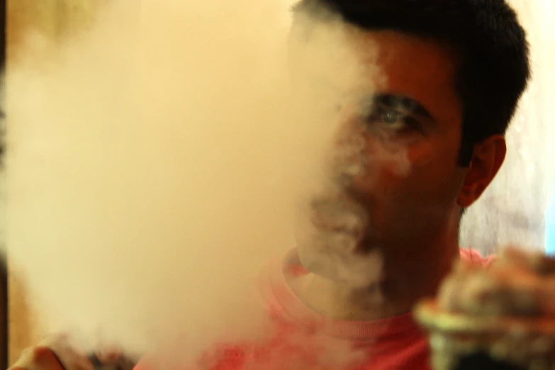 a man that has smoke coming from his face